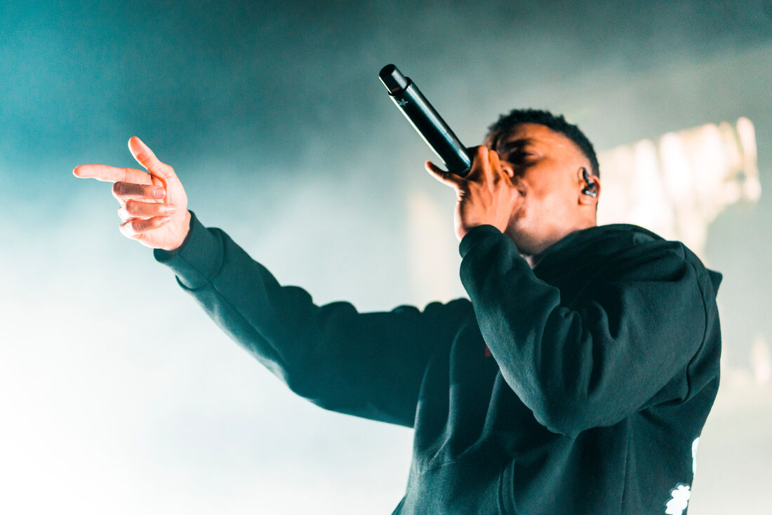 Rapper pointing to the crowd at a D.C. venue