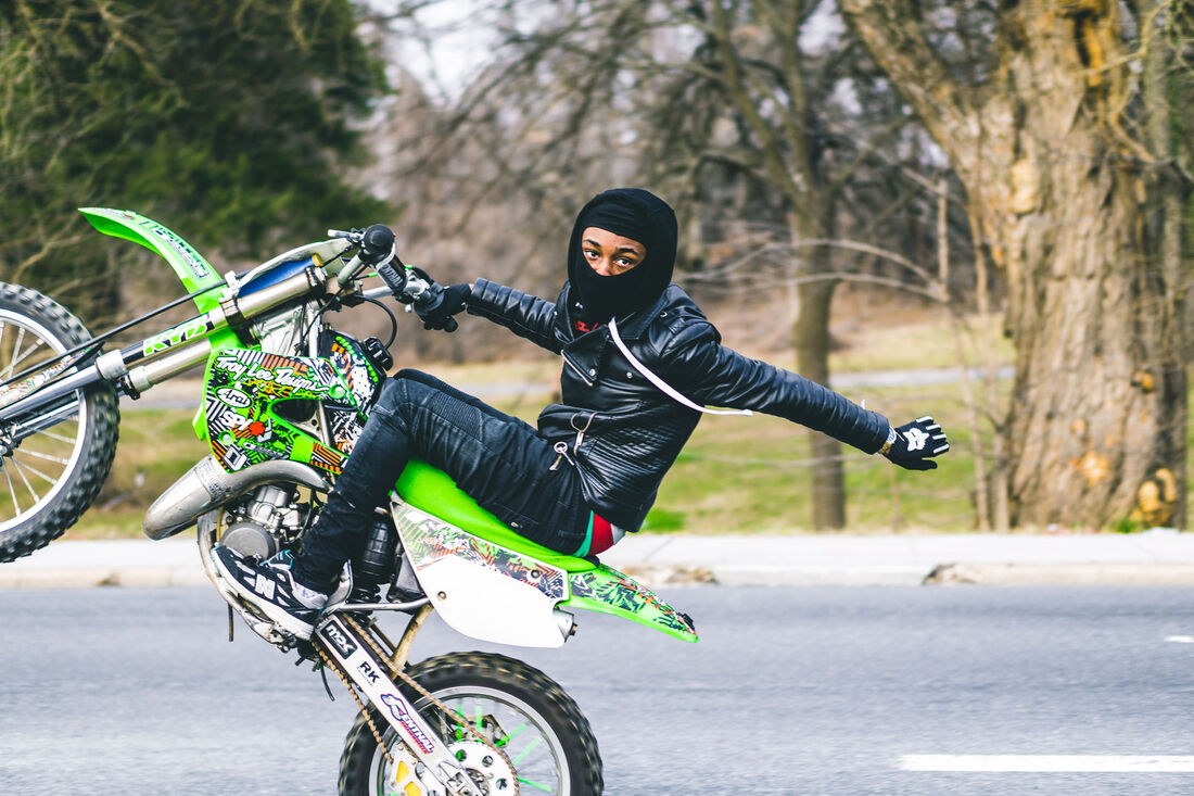 Dirt bike wheelie on a Baltimore street